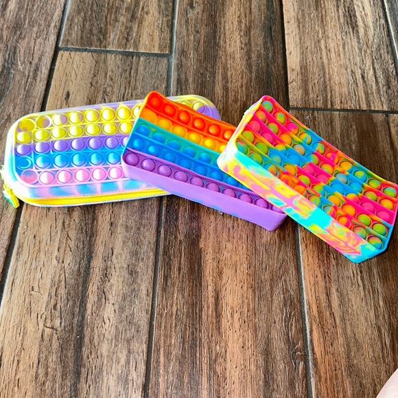 Other - 3 pop it pencil cases, colors: tie-die, rainbow. Good for school.